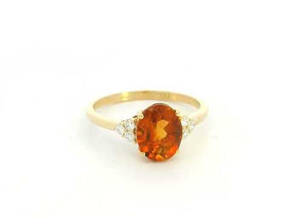 Oval citrine and diamond ring in 18K yellow gold with natural citrine center stone and diamond side accents