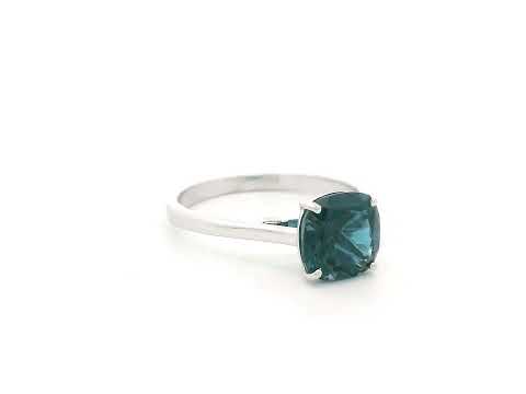 2.42 carat cushion cut London Blue Topaz solitaire ring in 18K white gold.