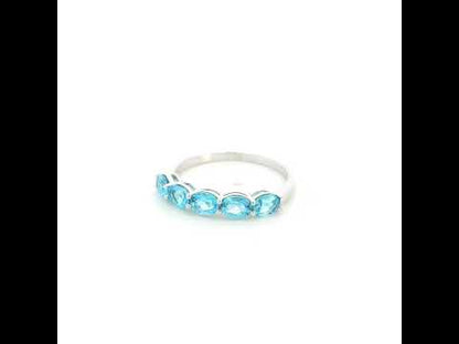 Blue Topaz five stone ring in 18K white gold featuring five oval blue topaz gemstones totaling 1.42 carats