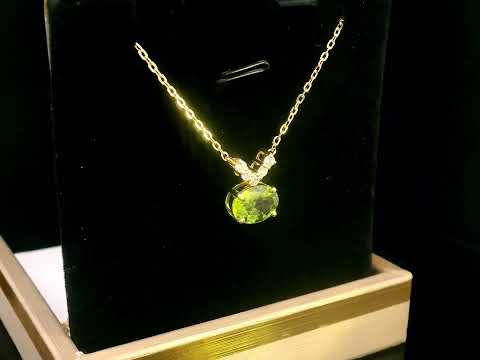 18K gold necklace featuring a 1.68-carat oval Peridot pendant with a 0.15-carat diamond cluster accent in a V-shape, suspended from a fine gold chain.