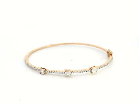 18K gold diamond bangle featuring round-cut and baguette-cut diamonds totaling 0.69 carats

