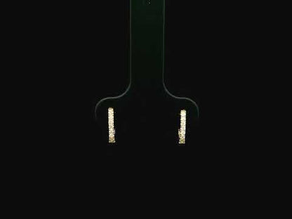 18K yellow gold diamond huggie hoop earrings featuring 0.09 carats of natural diamonds in a classic everyday hoop design.
