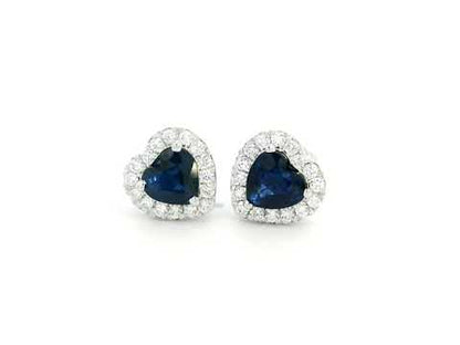 18K white gold heart-shaped sapphire and diamond halo stud earrings featuring a 1.40-carat deep blue sapphire and 0.33-carat round diamonds, perfect for fine jewelry lovers, birthdays, and September birthstone gifts.