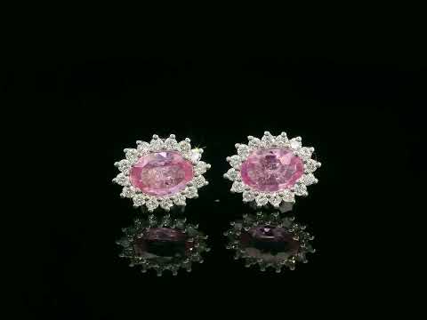 Oval pink sapphire stud earrings with diamond starburst halo in 18K gold