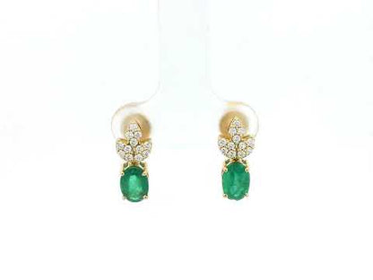 Emerald and diamond accent earrings in 18K yellow gold featuring 1.14 carat emeralds and 0.19 carat diamonds by Emirates Diamonds.