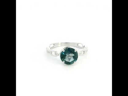 Round London Blue Topaz diamond ring in 18K white gold with sculpted open-detail band