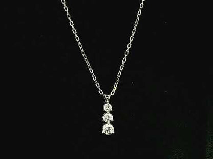 18K white gold three stone natural diamond journey pendant necklace featuring 0.36 carat round brilliant diamonds in a vertical prong setting with matching white gold chain.