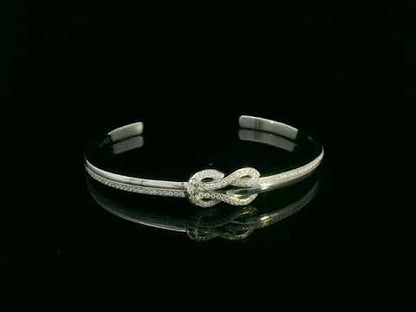 18K white gold diamond knot bangle with pavé-set natural diamonds by Emirates Diamonds