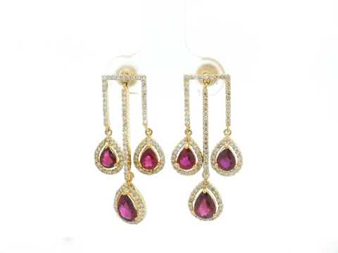 2.65 carat pear ruby and 0.91 carat diamond halo drop earrings in 18K yellow gold by Emirates Diamonds