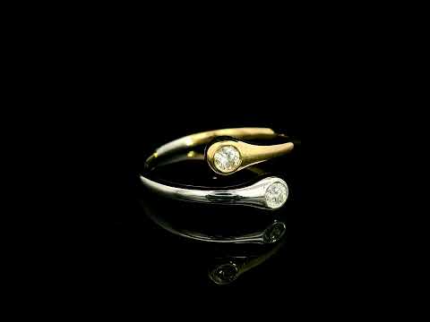 18K white and yellow gold bypass ring with two round diamonds in bezel settings at the ends of curved, overlapping bands.