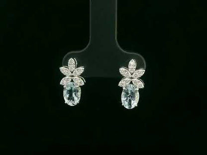 Video of 18k gold drop earrings with oval aquamarines and floral diamond cluster