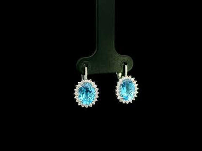 Oval Swiss Blue Topaz drop earrings with diamond halos in 18K white gold