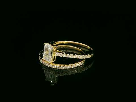 Emerald-cut diamond engagement ring and pavé wedding band bridal set in 18K yellow gold – Emirates Diamonds.