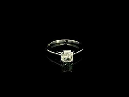 Radiant cut diamond solitaire engagement ring in 18K white gold with a four-prong setting and polished band.