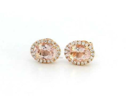 Elegant 18K gold stud earrings featuring 1.40 carats of oval-cut morganite gemstones, each encircled by a halo of 0.19 carats of round diamonds, secured with a push-back closure for timeless sophistication.







