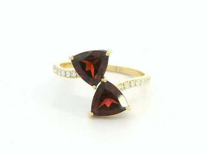 18K yellow gold open bypass ring with trillion-cut garnets and pavé diamonds, modern luxury design