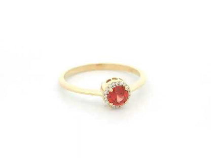 Orange sapphire diamond halo ring in 18K yellow gold by Emirates Diamonds
