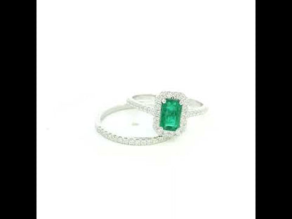 18K white gold emerald bridal set featuring a 0.71 carat natural emerald-cut emerald with a diamond halo and matching diamond wedding band.