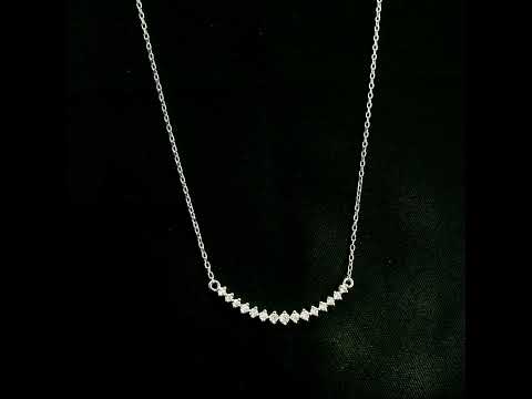 Diamond curved bar necklace in 18K white gold featuring a gently curved row of round diamonds with a total weight of 0.18 carat, connected to a fine white gold chain.