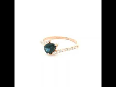 Natural pear-shaped blue sapphire ring in 18K rose gold featuring a 0.78 carat blue sapphire with a bypass diamond band set with 0.19 carat natural diamonds.