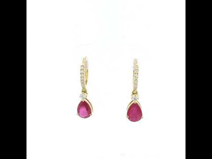 Pear-shaped ruby drop earrings with diamond-set huggie hoops in 18K yellow gold by Emirates Diamonds.