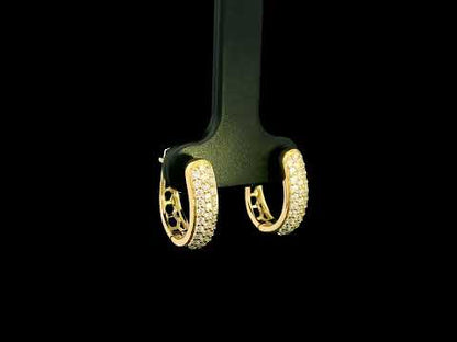 18K yellow gold diamond huggie hoop earrings featuring 0.51 carat natural round brilliant pavé-set diamonds with a secure hinged closure.