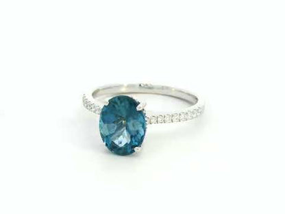 18K white gold ring featuring a 2.66 carat oval London Blue Topaz with diamond-set band, total diamond weight 0.25 carat – Emirates Diamonds