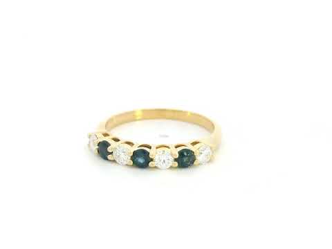 18K yellow gold half eternity ring featuring alternating natural blue sapphires and natural diamonds in a classic prong setting.