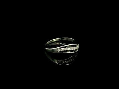 18K white gold diamond wave ring with a curved row of round diamonds and flowing polished gold design