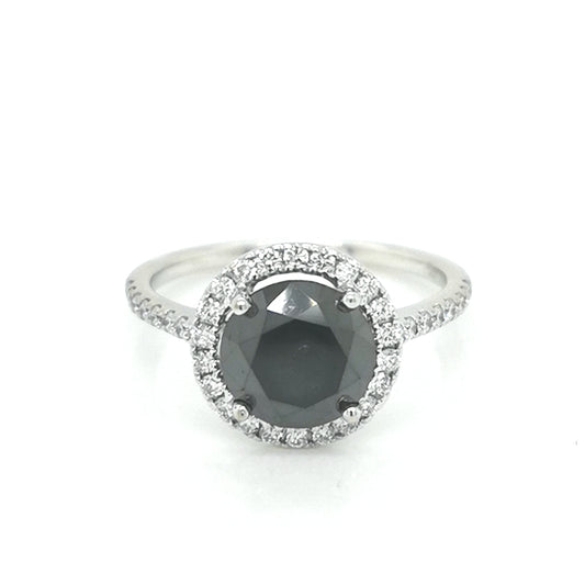Solitaire Black Diamond Ring With A Diamond Halo In 18k White Gold.