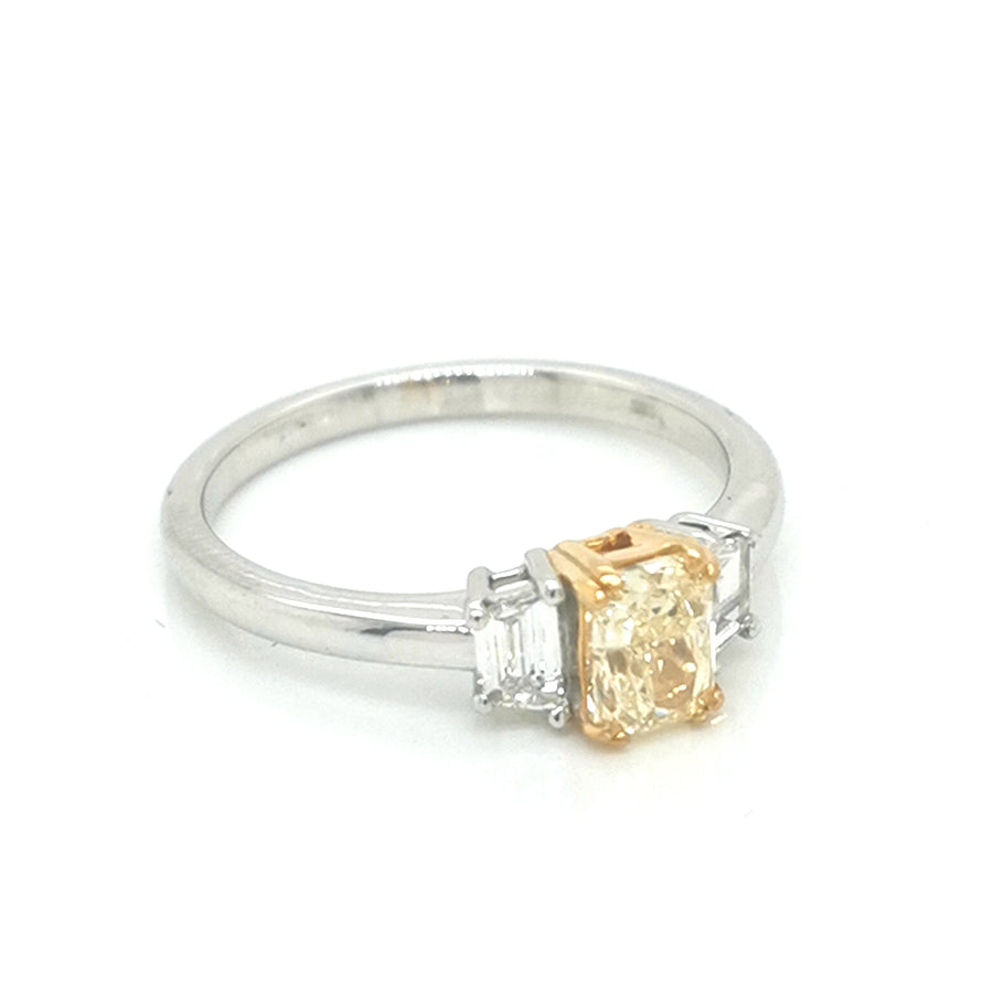 Fancy Yellow Diamond Ring With Trapezoid Side Stones In 18k White Gold.
