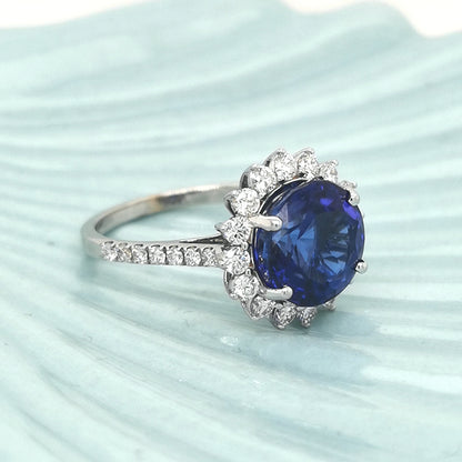 Tanzanite And Diamond Halo Ring In 18k White Gold. Birthstone For The Month Of December