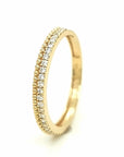 This Piece Is A Chic Take On The Classic Eternity Band. A Row Of Diamonds Is Set Along The Side Of A Row Of Shinning Golden Beads In This Design. This Eternity Ring Can Be Used As A Stacking Ring Or As A Wedding Ring.