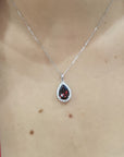 Pear Shape Garnet And Diamond Pendant Crafted In 18K White Gold