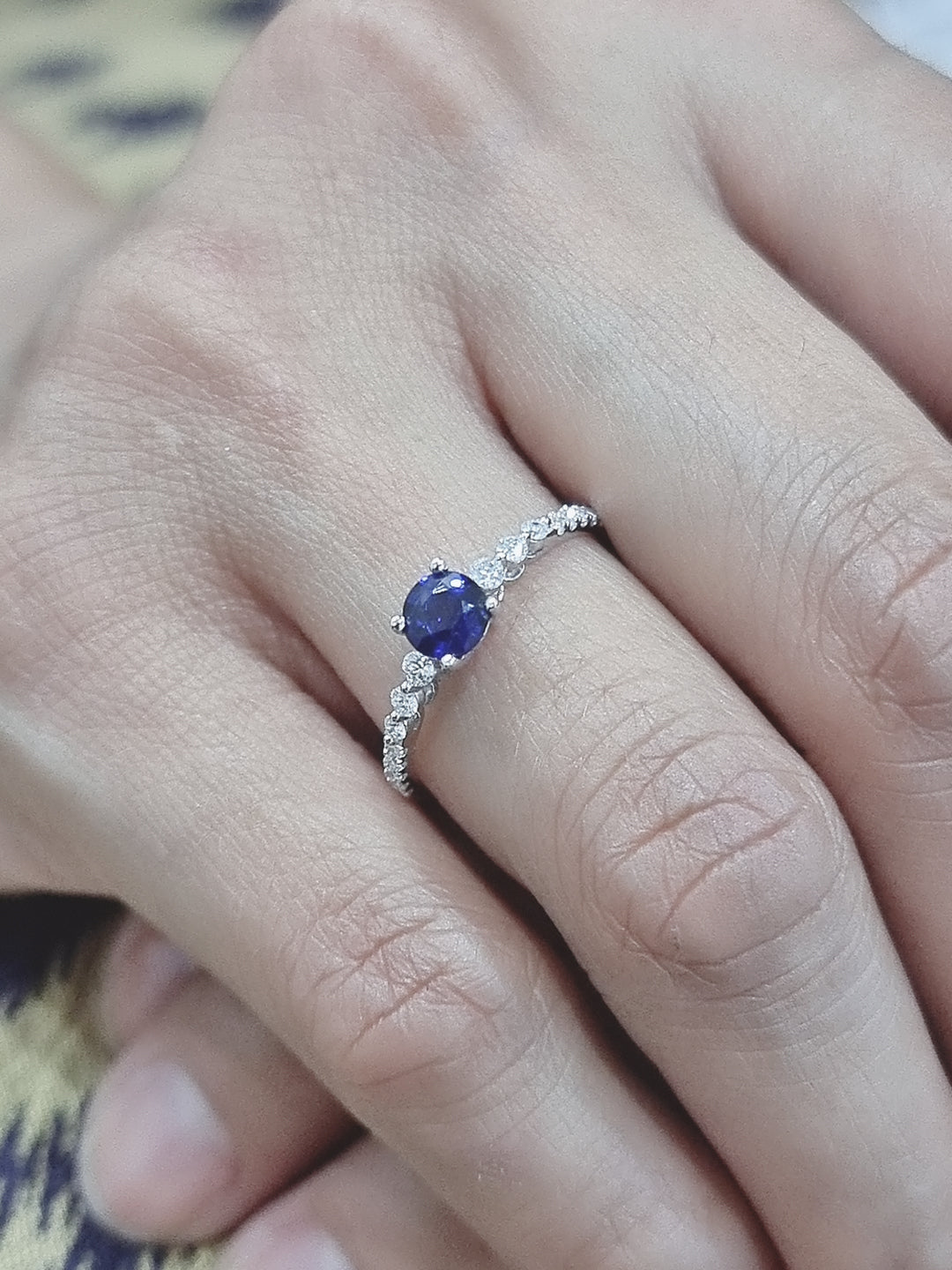 Traditionally Diamonds Are Most Prefered Choice For Engagement Rings. Gemstone Rings Are A Trendy Alternative. Both Diamonds And Sapphires Are Rare And Precious, But The Combination Of Both Not Only Reduces The Cost But Also Make A Gorgeous Ring That Truly Stands Out.  This Marvelous Ring Features A Solitaire Deep Blue Round Cut Sapphire secured In Four Prog, Round Cut Brilliant Diamonds Graduates Flowing Down The Shank Half Way. Eye Catching Design Is Sure To Draw Many Compliments.