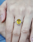 Yellow Sapphire And Diamond Halo Ring In 18k White Gold.