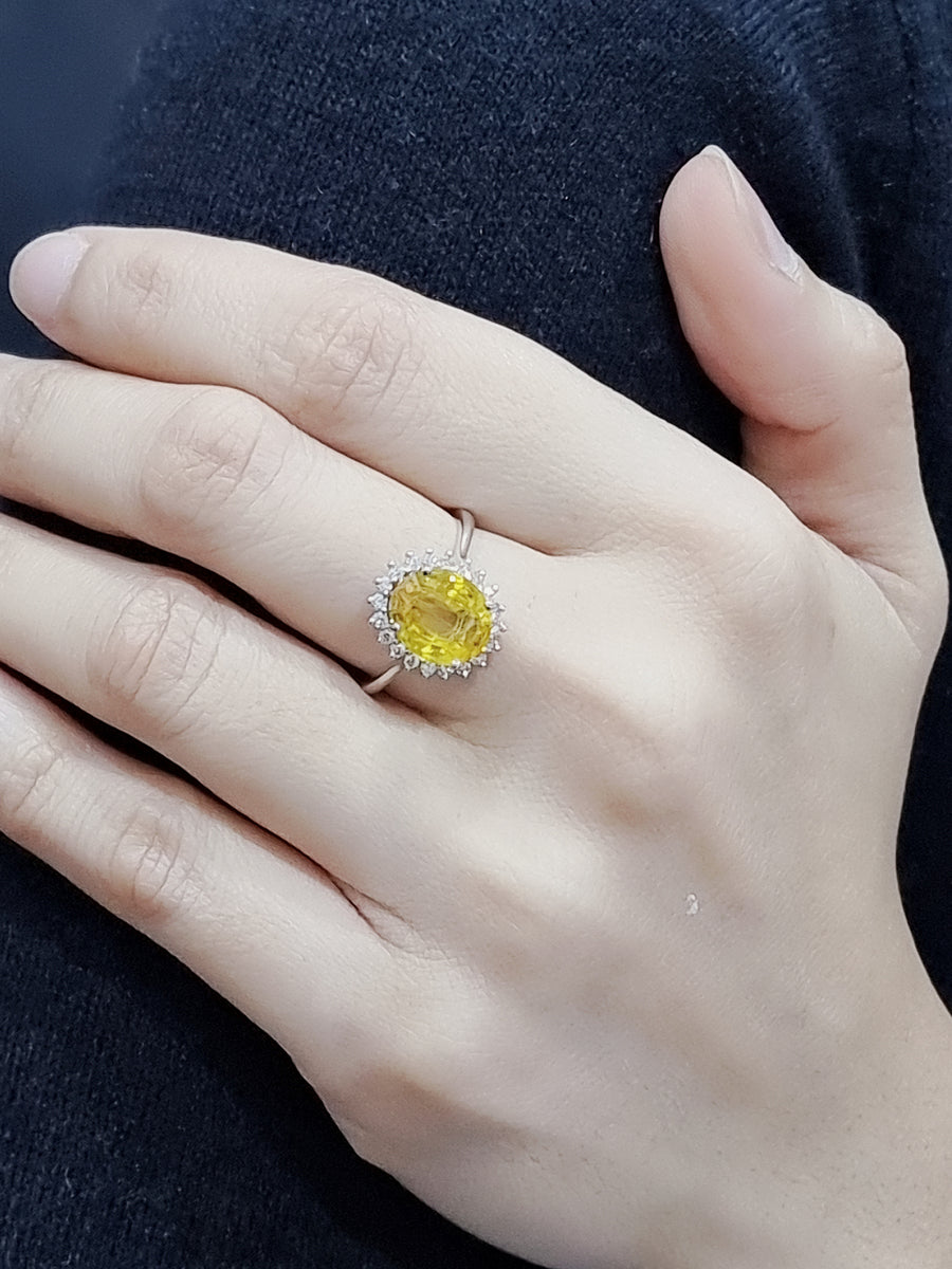 Yellow Sapphire And Diamond Halo Ring In 18k White Gold.