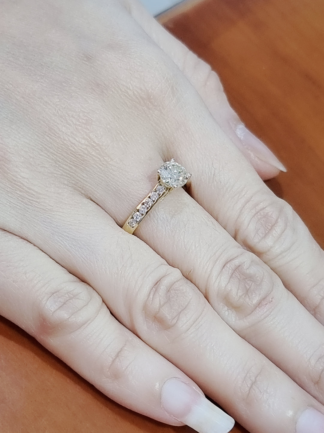 Solitaire Diamond Ring With Channel Set Accent Diamonds In 18k Yellow Gold.
