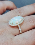 Elongated Oval Shape Opal With Diamond Halo Ring In18k Yellow Gold.