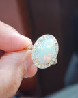 Elongated Oval Shape Opal With Diamond Halo Ring In18k Yellow Gold.