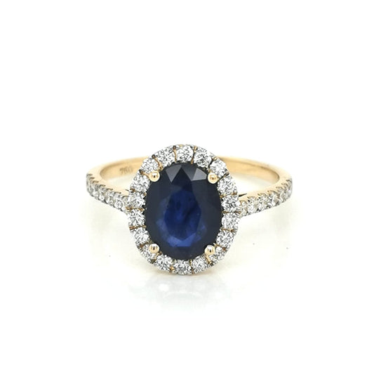 Oval Shape Blue Sapphire With Diamond Halo Ring Crafted In 18K Yellow Gold