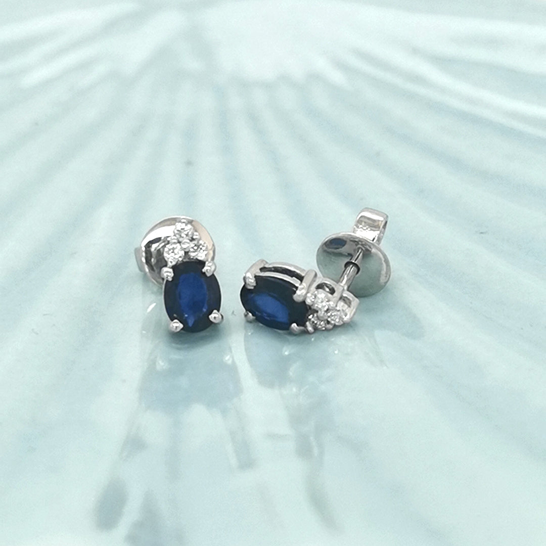 Oval Cut Blue Sapphire And Diamond Stud Earrings In 18k White Gold.