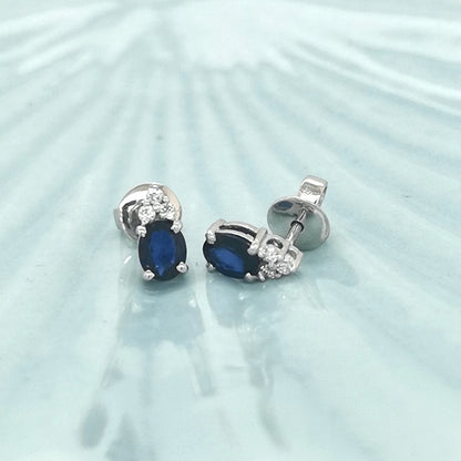 Oval Cut Blue Sapphire And Diamond Stud Earrings In 18k White Gold.