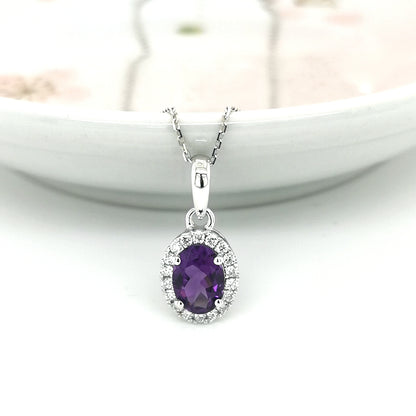 Oval Amethyst And Diamond Halo Pendant In 18k White Gold.
